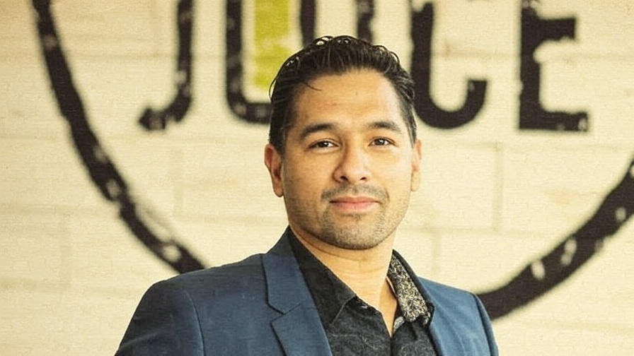 Indian-American entrepreneur Amol Kohli with Friendly’s signage, representing business growth and franchise success.